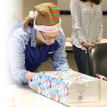 Tracy wraps Christmas presents for fellow employees.