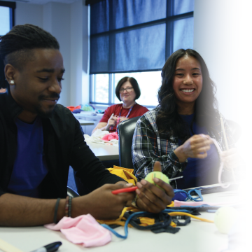 Kendall and Shannon from local branches are volunteering by putting together toys for pets