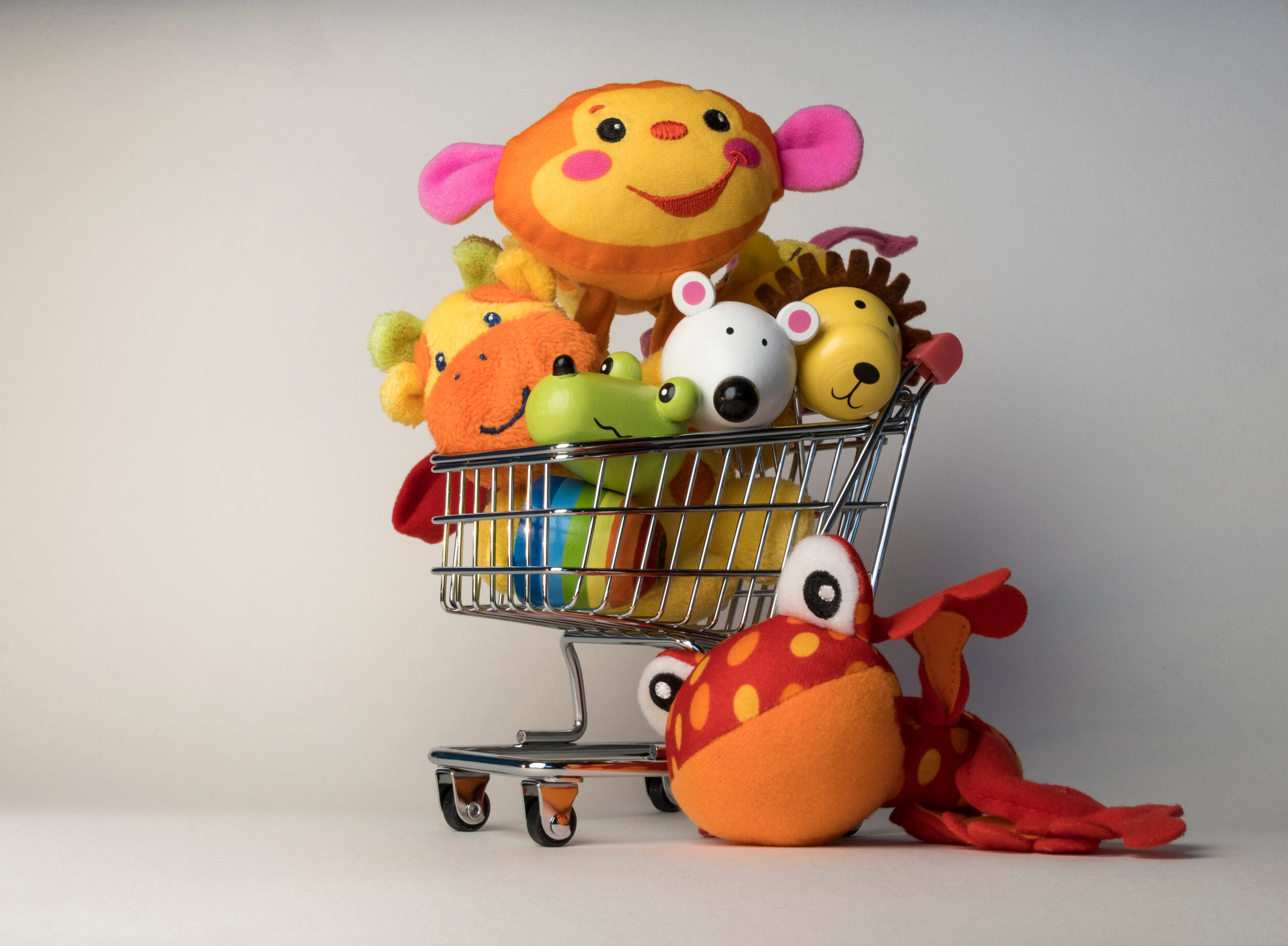 A shopping cart full of stuff animals.