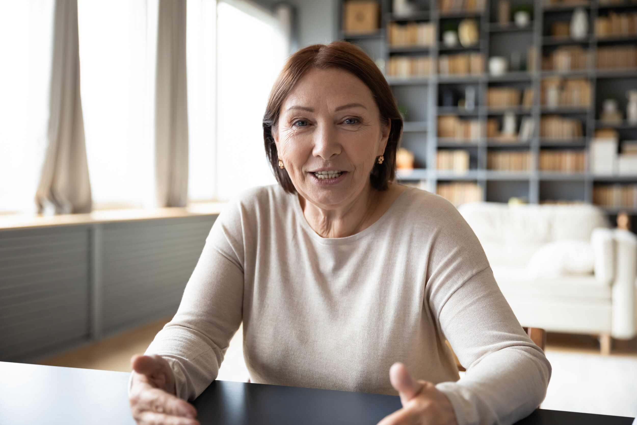 A woman looking at the camera as if she's explaining something.