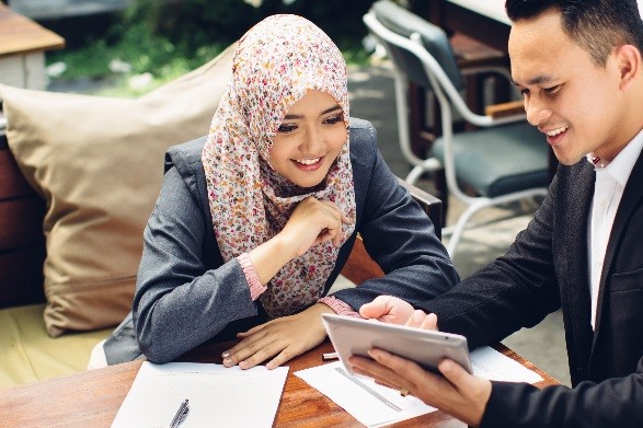 Two people reviewing budgets