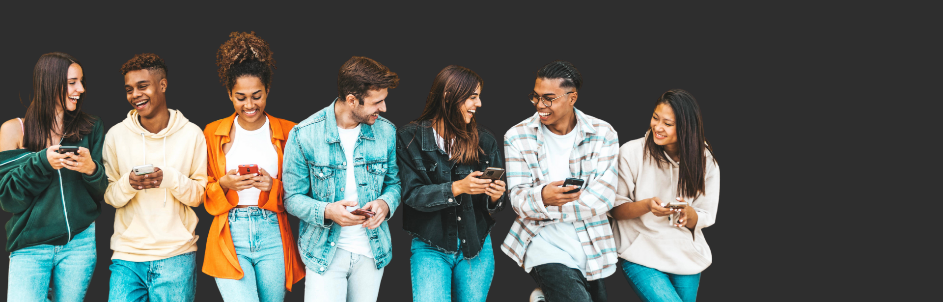 group of young adults smiling on phones