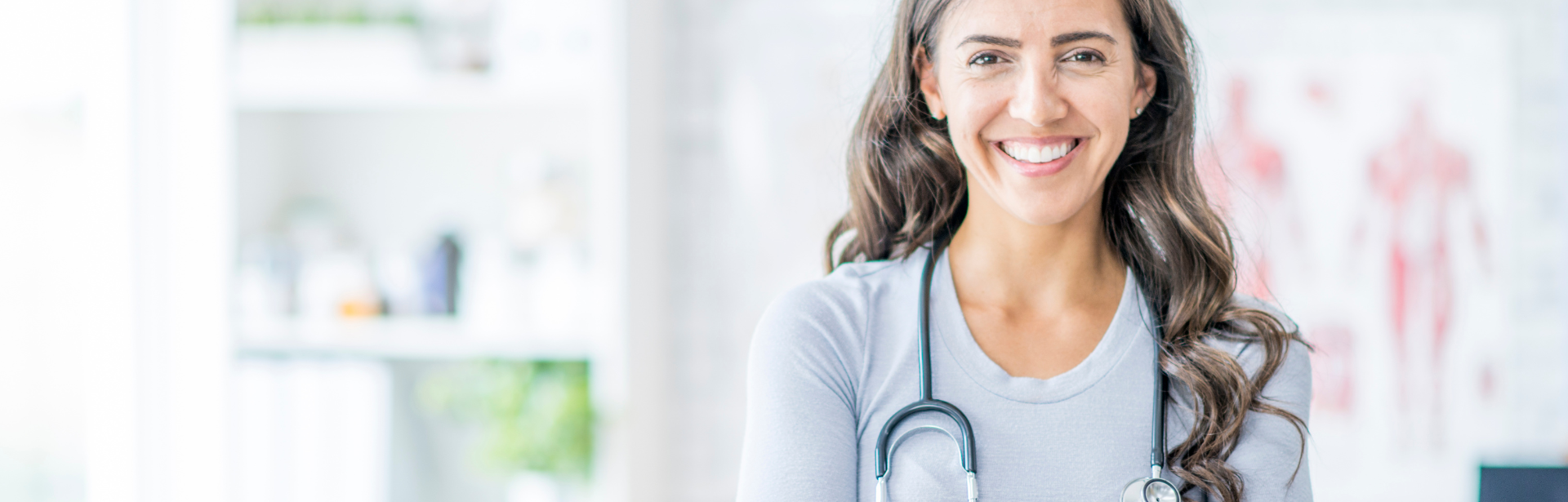 young woman with stethoscope smiling