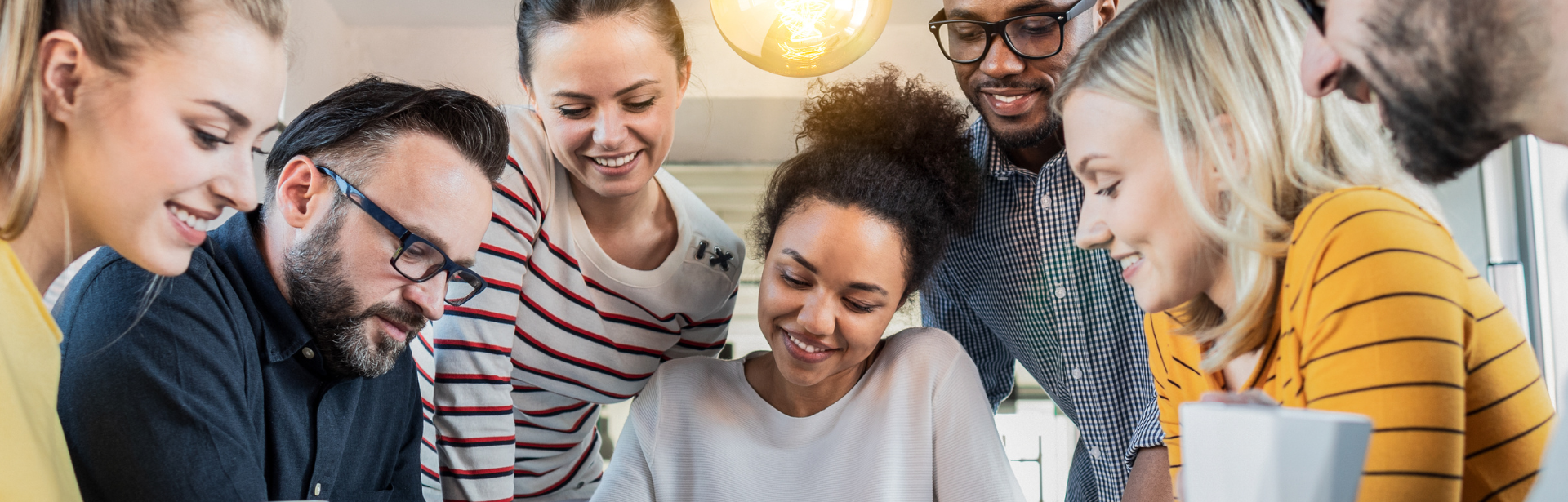 group of team members looking at laptop